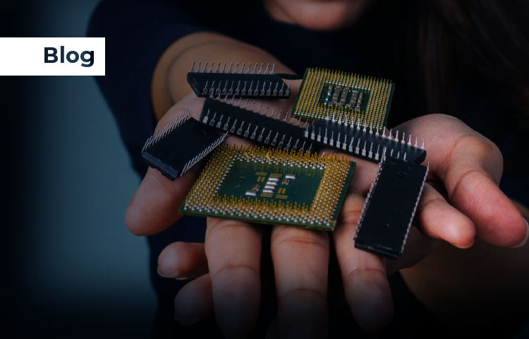 Hands holding several integrated circuits and microchips, showcasing different types of electronic components.
