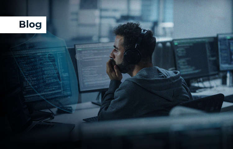 A person wearing headphones working on multiple computer screens displaying code, with a faint image of a lock symbol overlaying the scene, indicating cybersecurity.